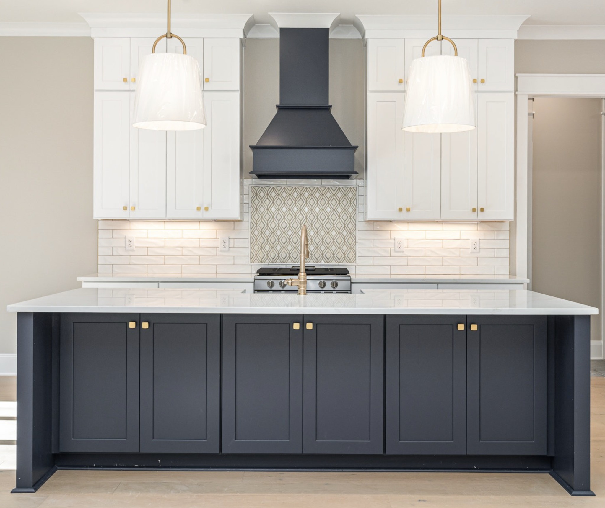 White shaker kitchen cabinets with blue island and modern hardware in Raleigh, NC home.